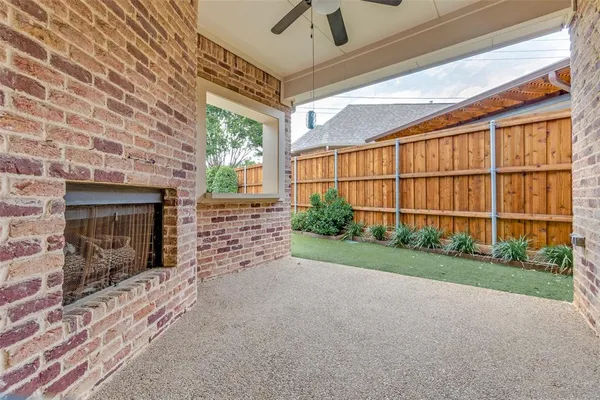 a view of an empty room with a fireplace and a window