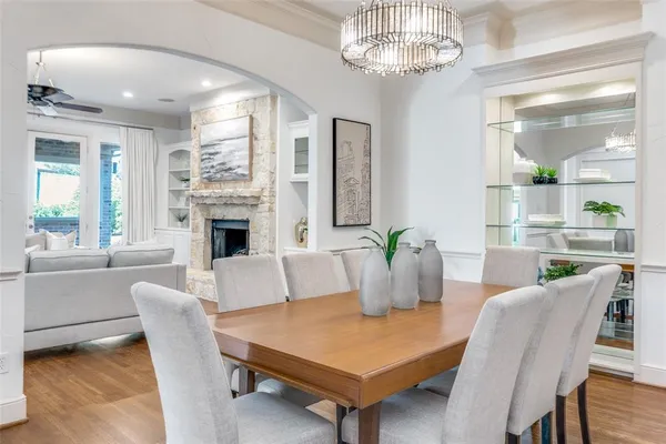 a view of a dining room with furniture wooden floor and chandelier