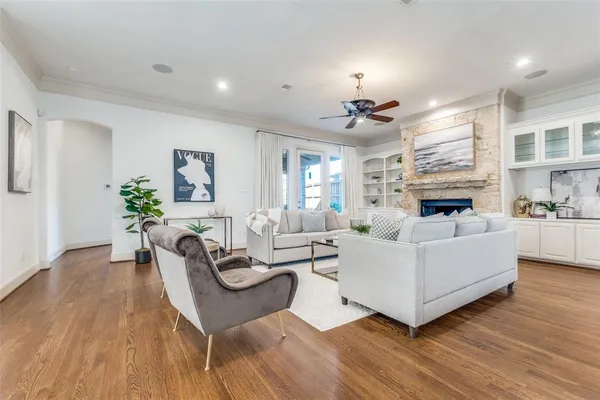a living room with furniture fireplace and wooden floor