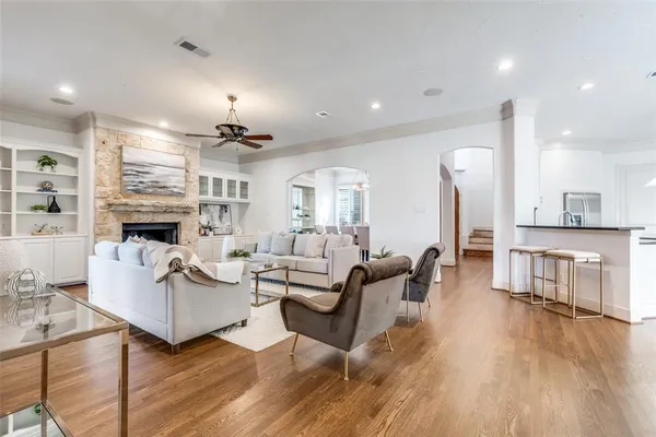 a living room with fireplace furniture and a wooden floor