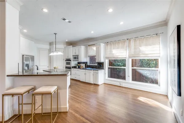 a large kitchen with a table and chairs in it