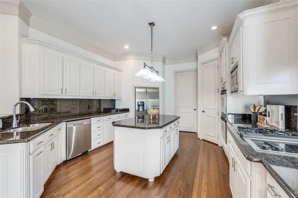 a kitchen with granite countertop a sink and cabinets