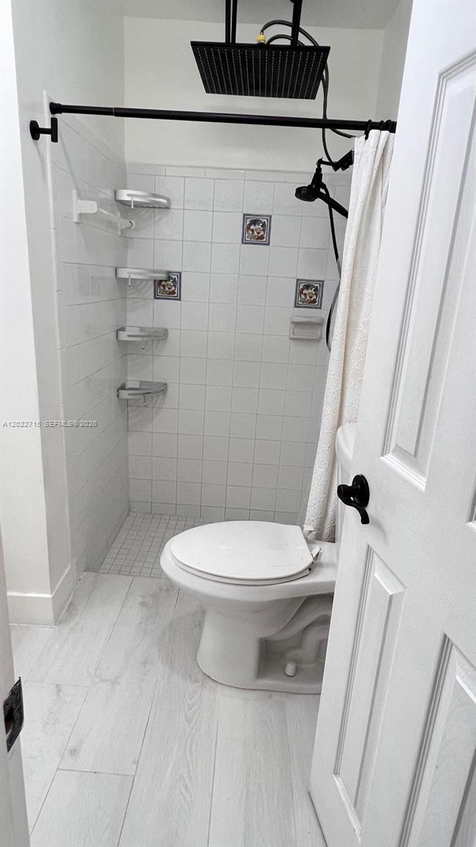 10669 Boca Entrada Boulevard Boca Raton, FL 33428 - Photo 13 of 19 a white toilet sitting next to a bath tub
