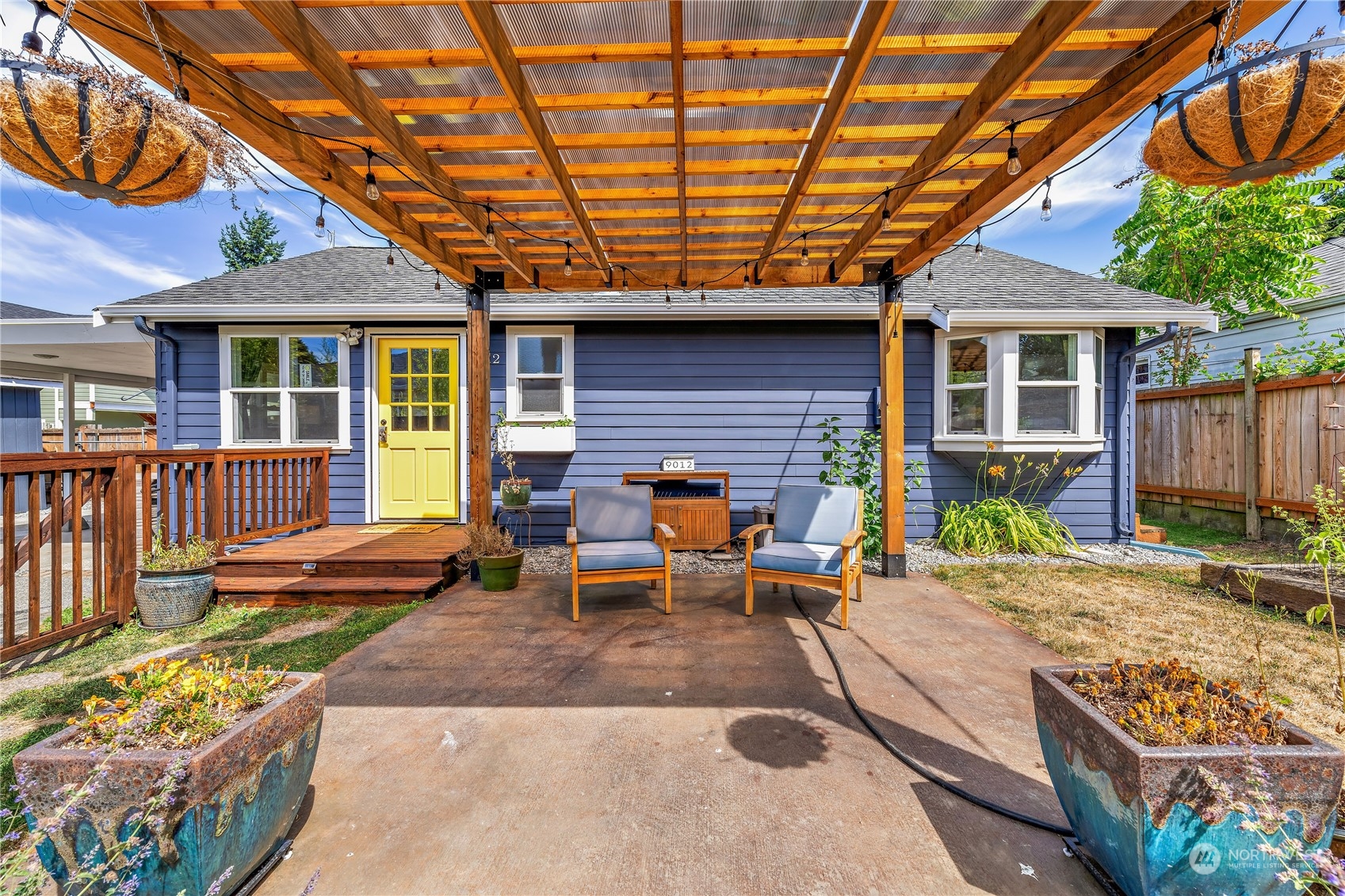 a view of a house with backyard porch and sitting area