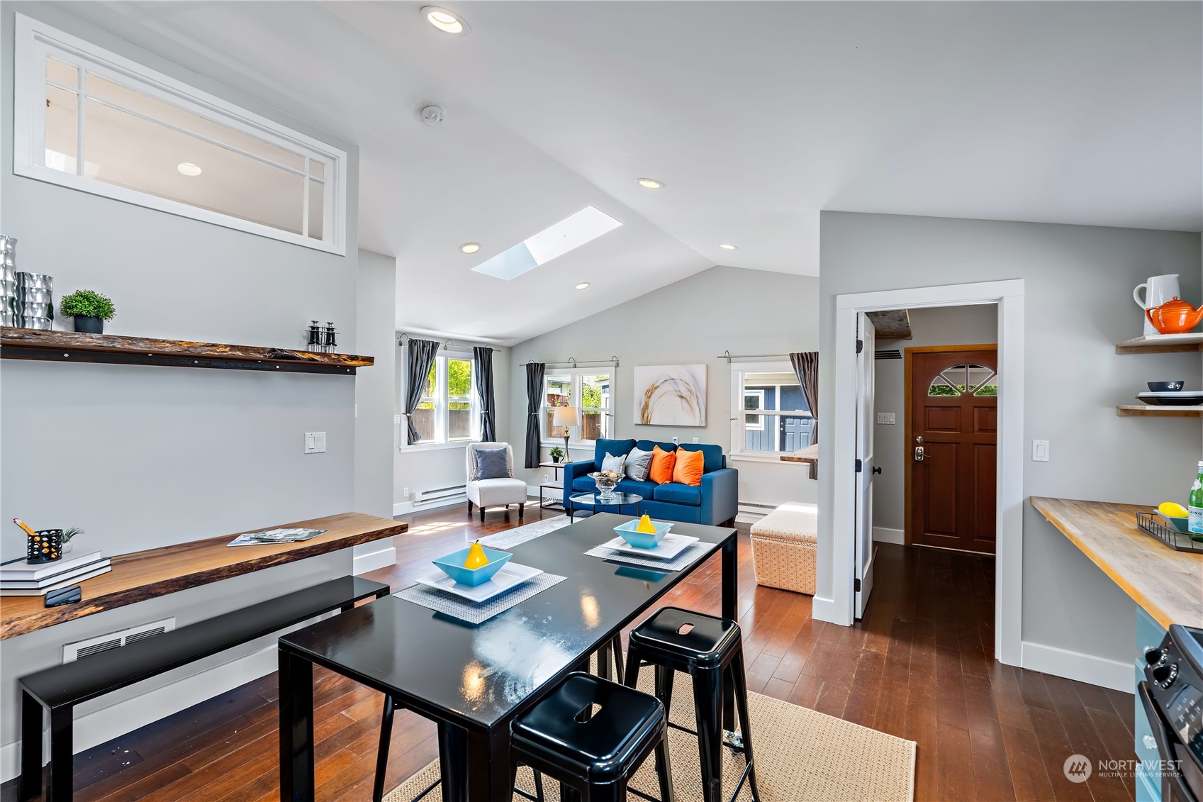 9012 7th Avenue Northwest Seattle, WA 98117 - Photo 15 of 36 a room with stainless steel appliances furniture dining table and wooden floor