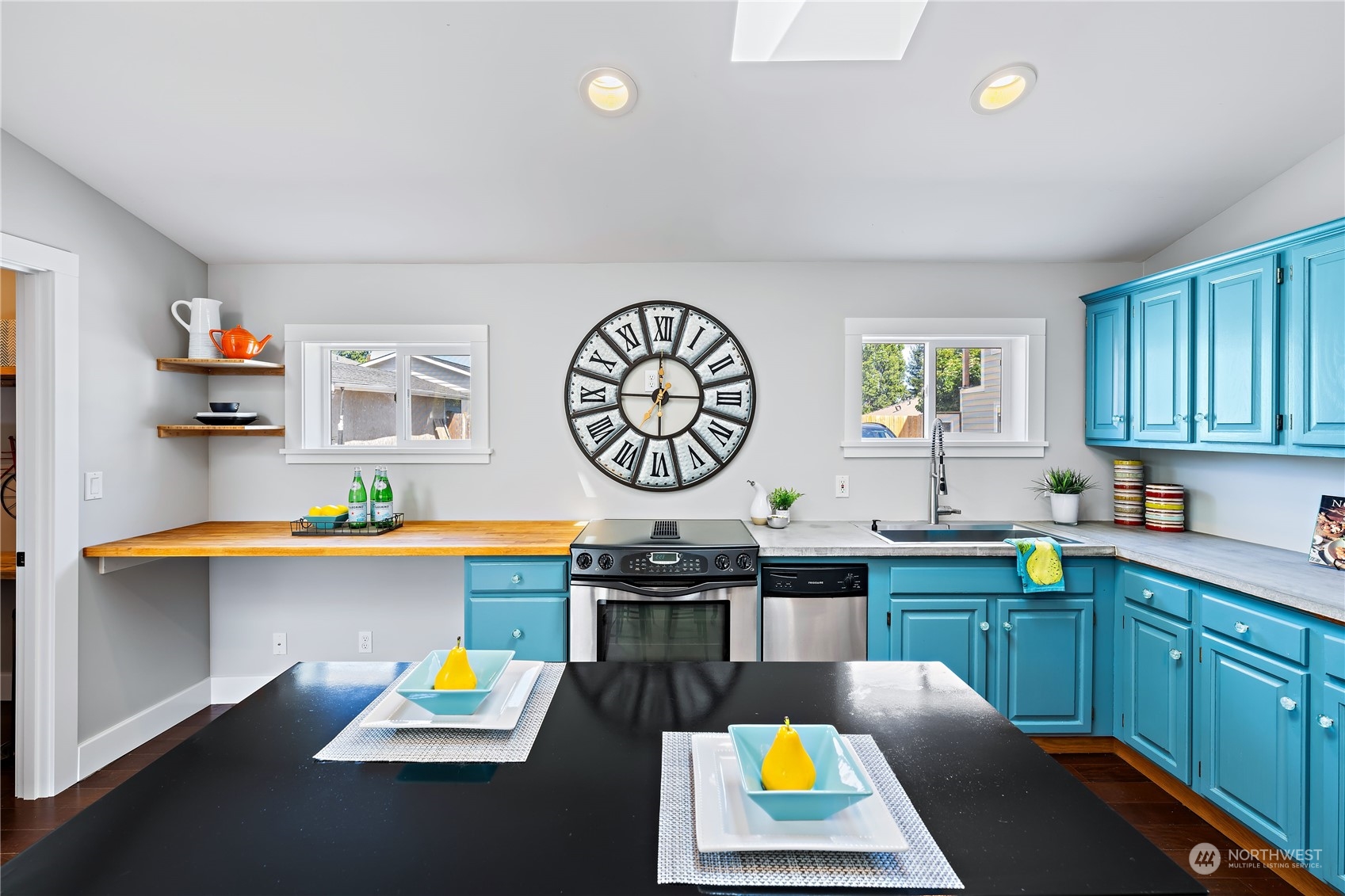 9012 7th Avenue Northwest Seattle, WA 98117 - Photo 16 of 36 a kitchen with a refrigerator and a stove top oven