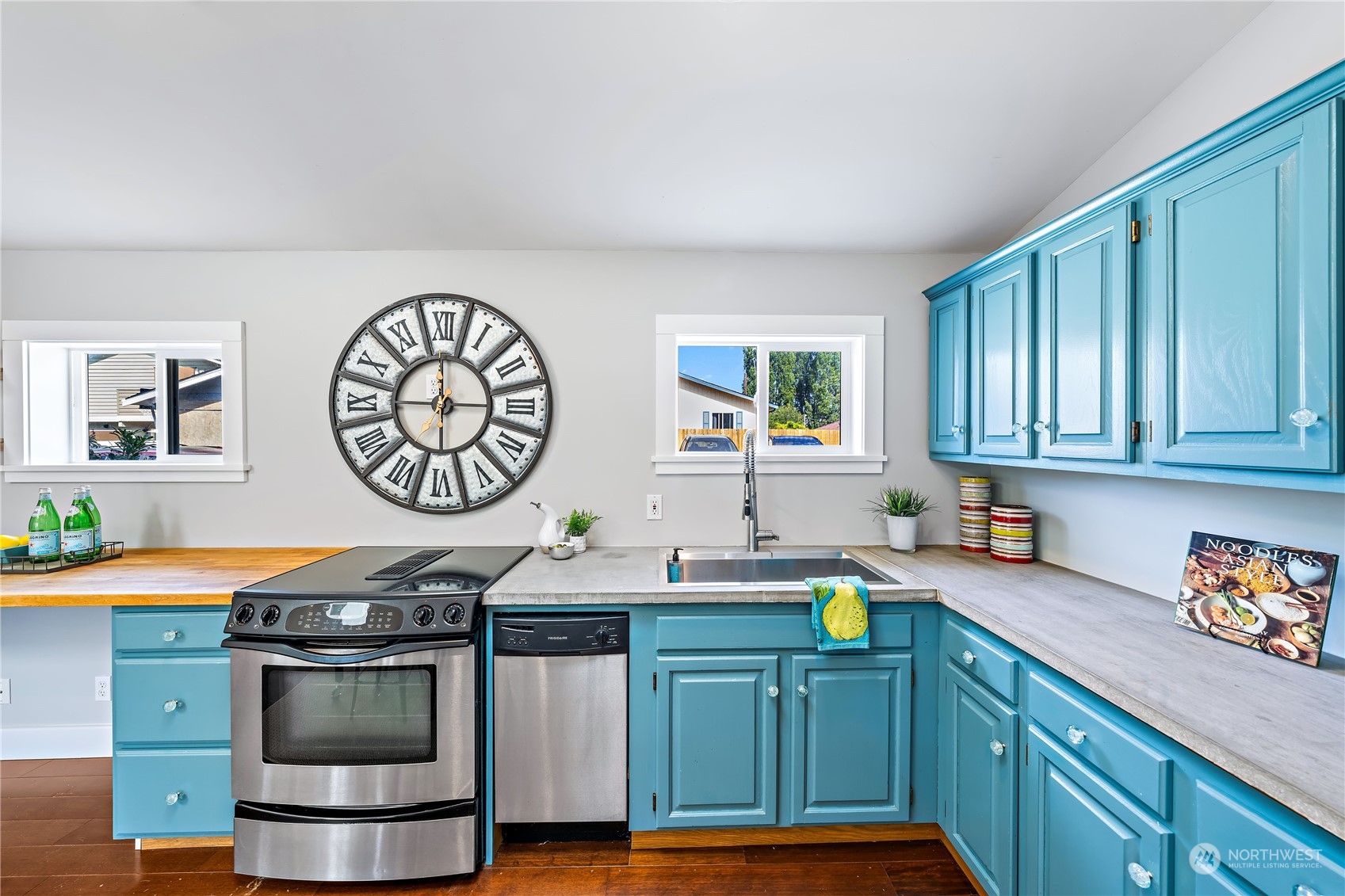9012 7th Avenue Northwest Seattle, WA 98117 - Photo 17 of 36 a kitchen with stainless steel appliances a stove a sink cabinets and a window
