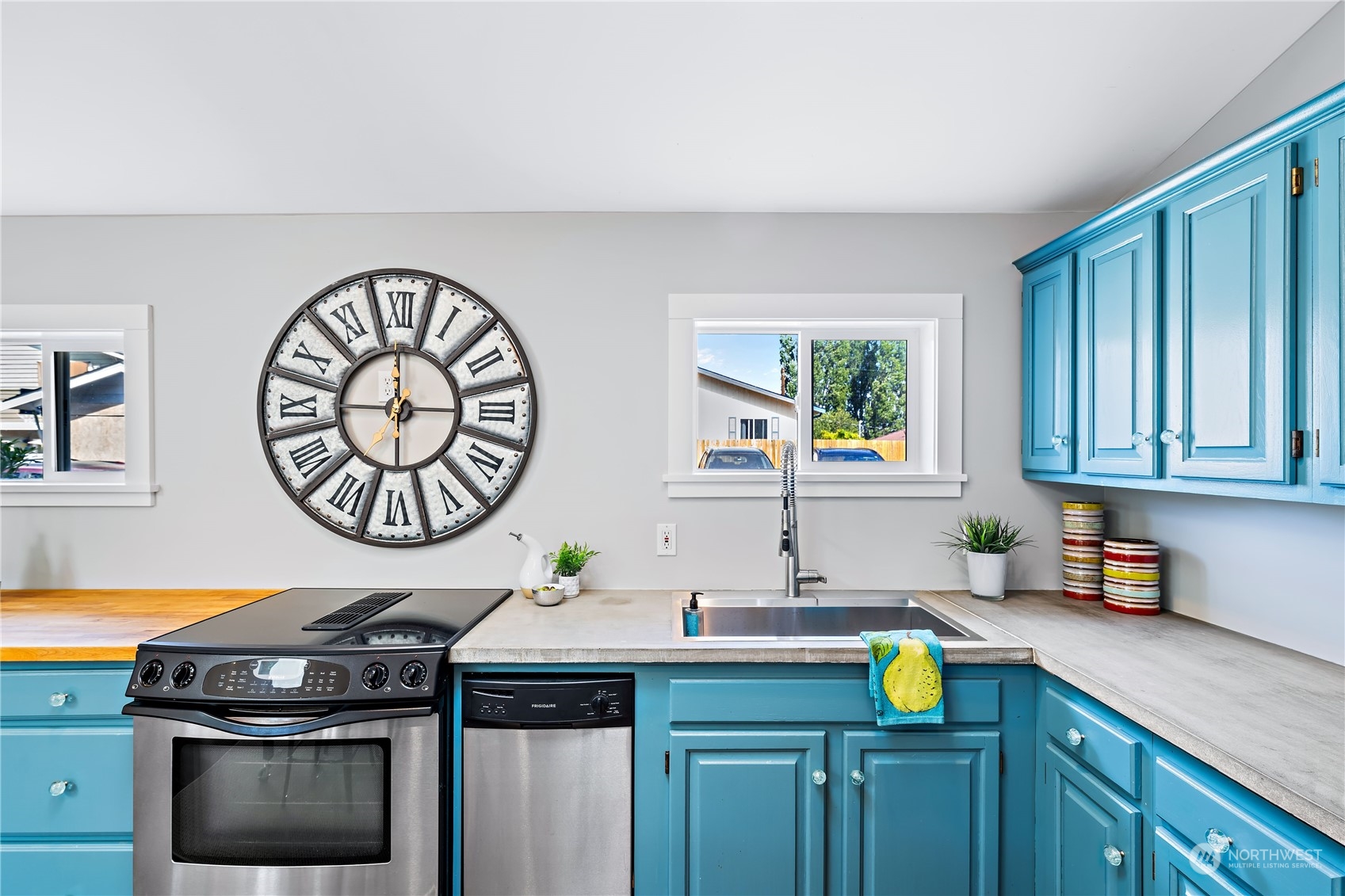 9012 7th Avenue Northwest Seattle, WA 98117 - Photo 18 of 36 a kitchen with a stove a sink and a stove top oven