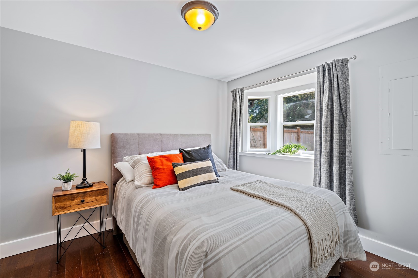 9012 7th Avenue Northwest Seattle, WA 98117 - Photo 21 of 36 a bedroom with a bed and a lamp next to a window