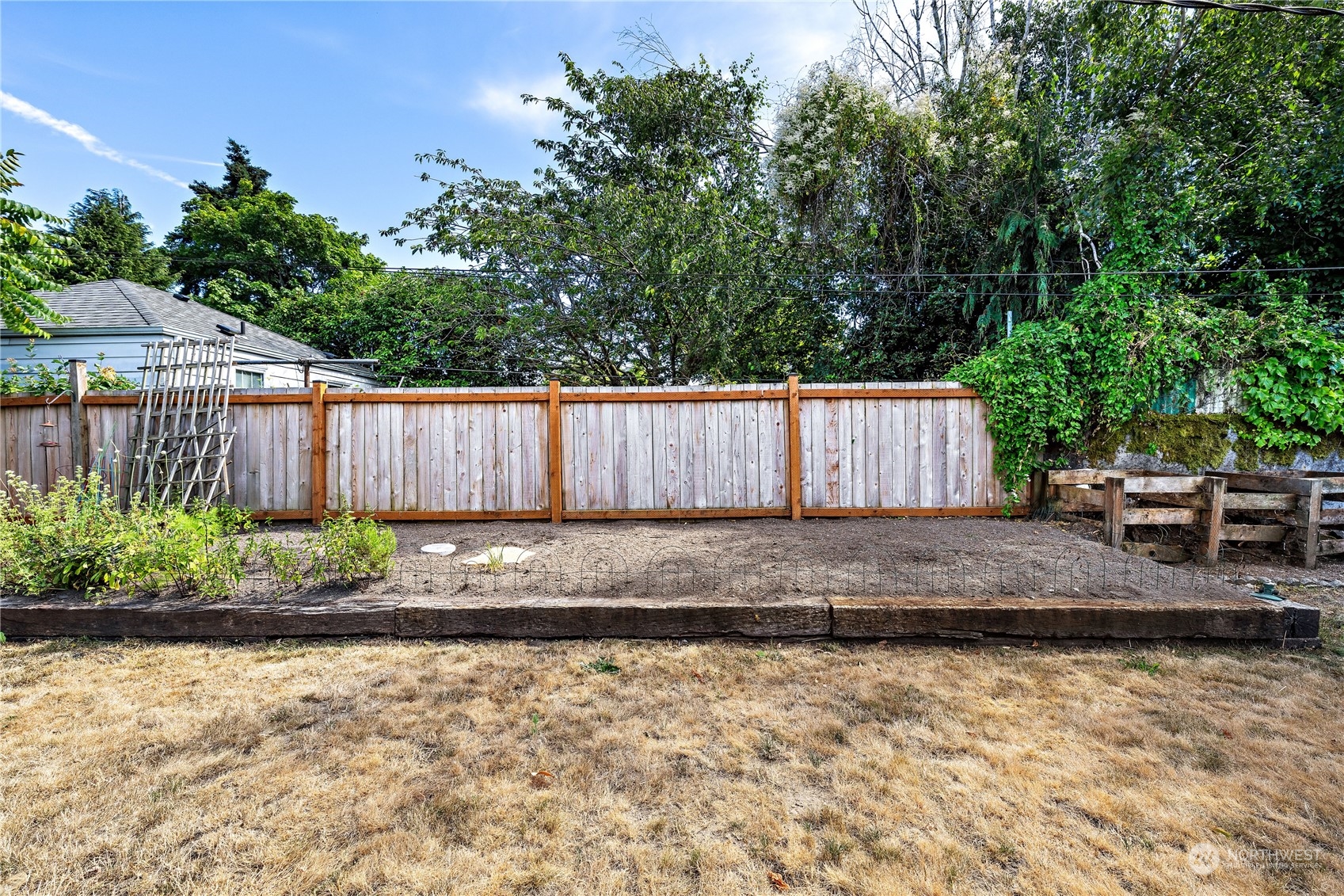 9012 7th Avenue Northwest Seattle, WA 98117 - Photo 31 of 36 a view of a backyard with large tree and wooden fence