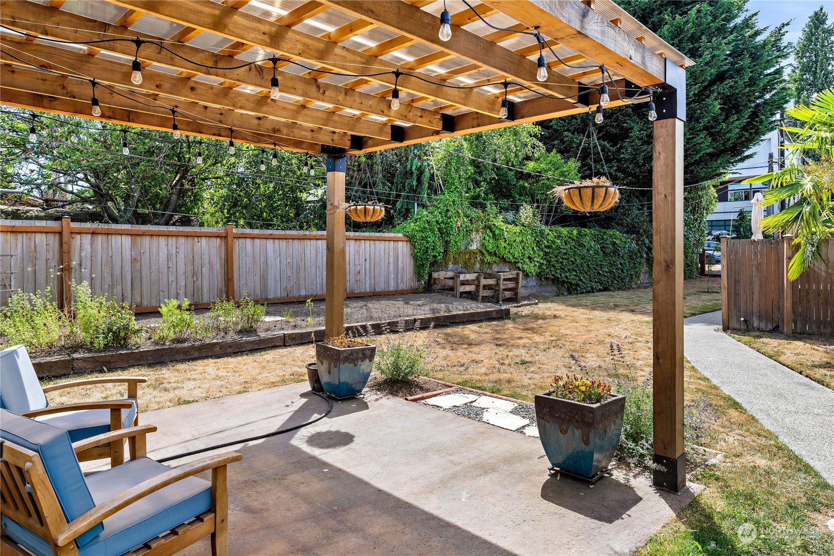 9012 7th Avenue Northwest Seattle, WA 98117 - Photo 4 of 36 a view of a patio with table and chairs potted plants with wooden floor