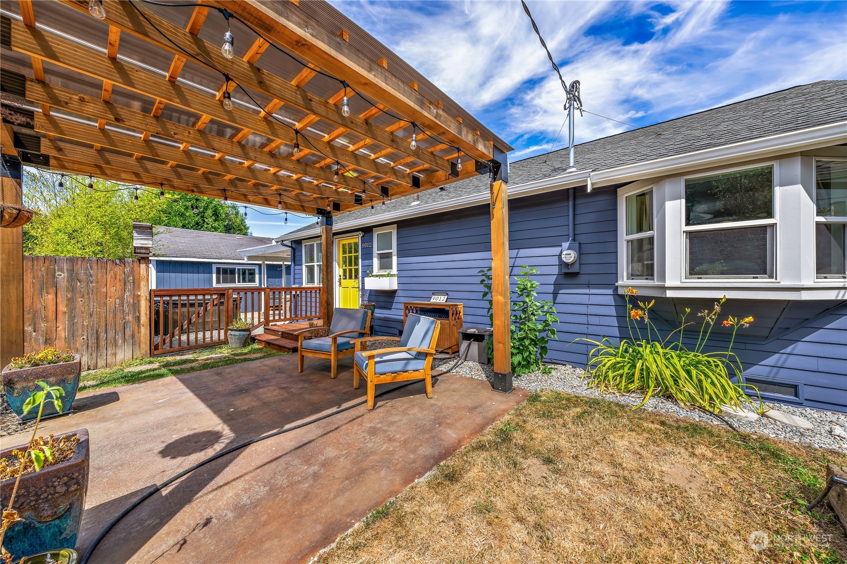 9012 7th Avenue Northwest Seattle, WA 98117 - Photo 5 of 36 a view of a patio with table and chairs under an umbrella