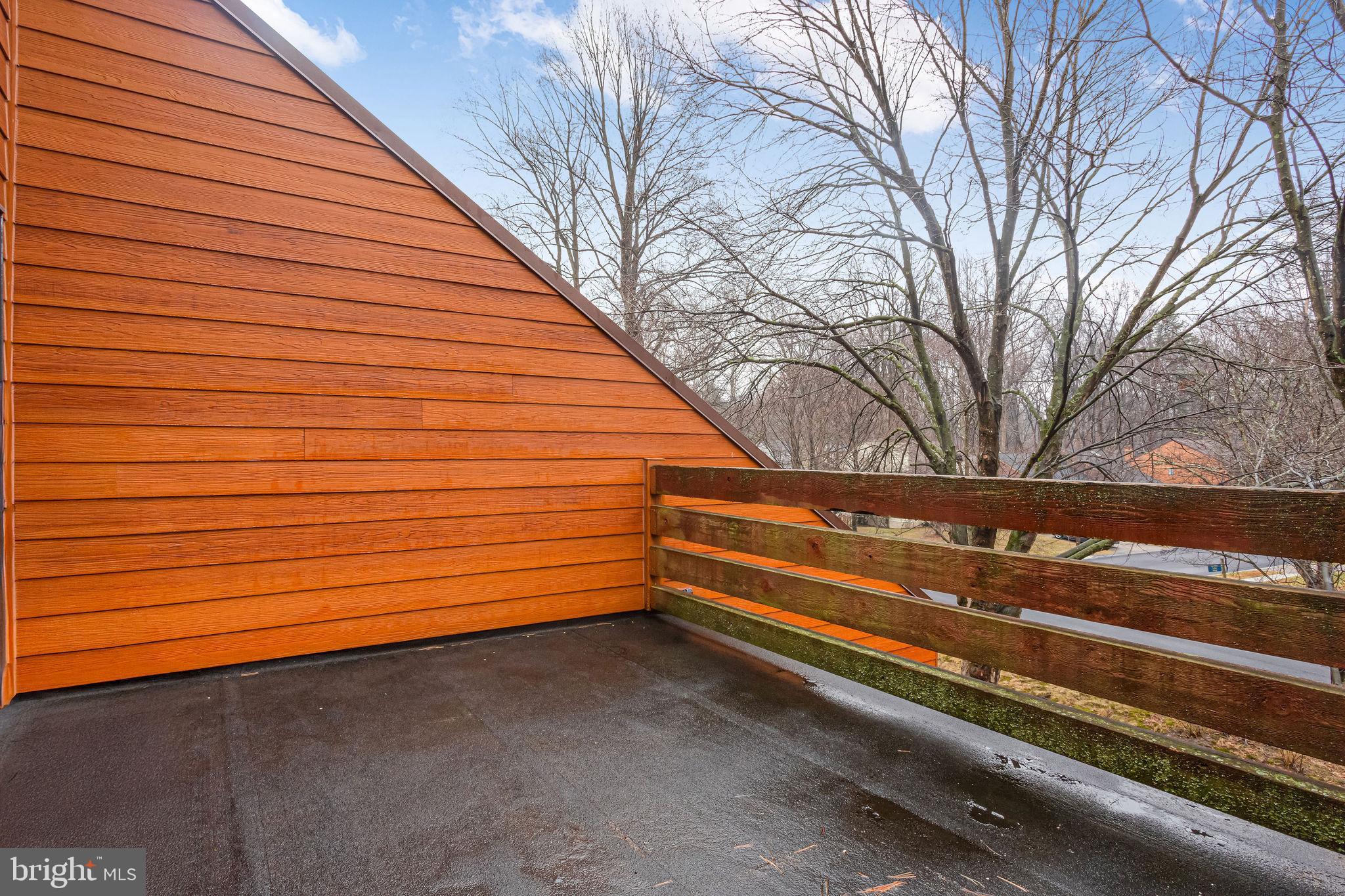 7579 Weather Worn Way, Unit D Columbia, MD 21046 - Photo 17 of 24 a view of backyard with wooden deck and a large tree