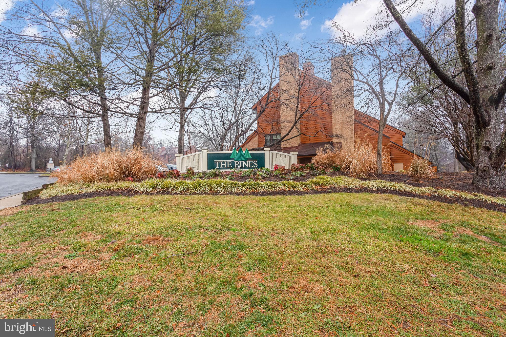 7579 Weather Worn Way, Unit D Columbia, MD 21046 - Photo 2 of 24 a backyard of a house with large trees and a barn