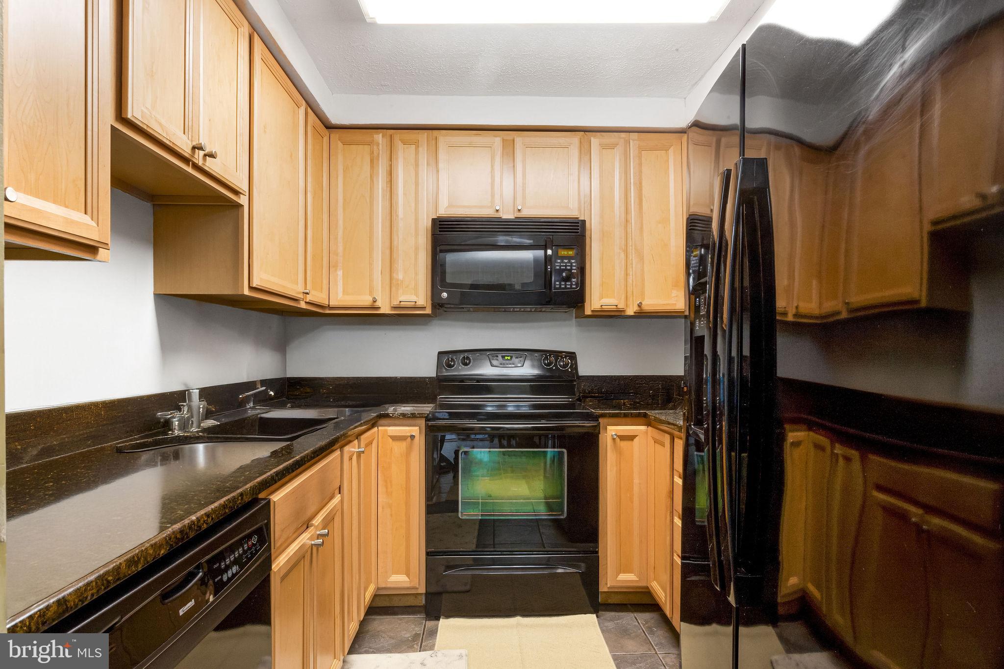 7579 Weather Worn Way, Unit D Columbia, MD 21046 - Photo 6 of 24 a kitchen with a stove and a microwave