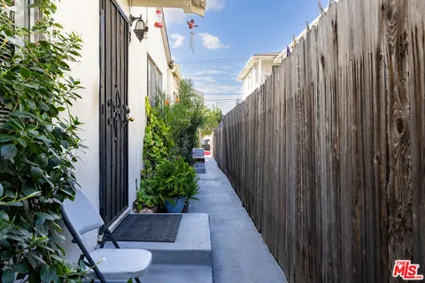 a view of a pathway of a wooden fence