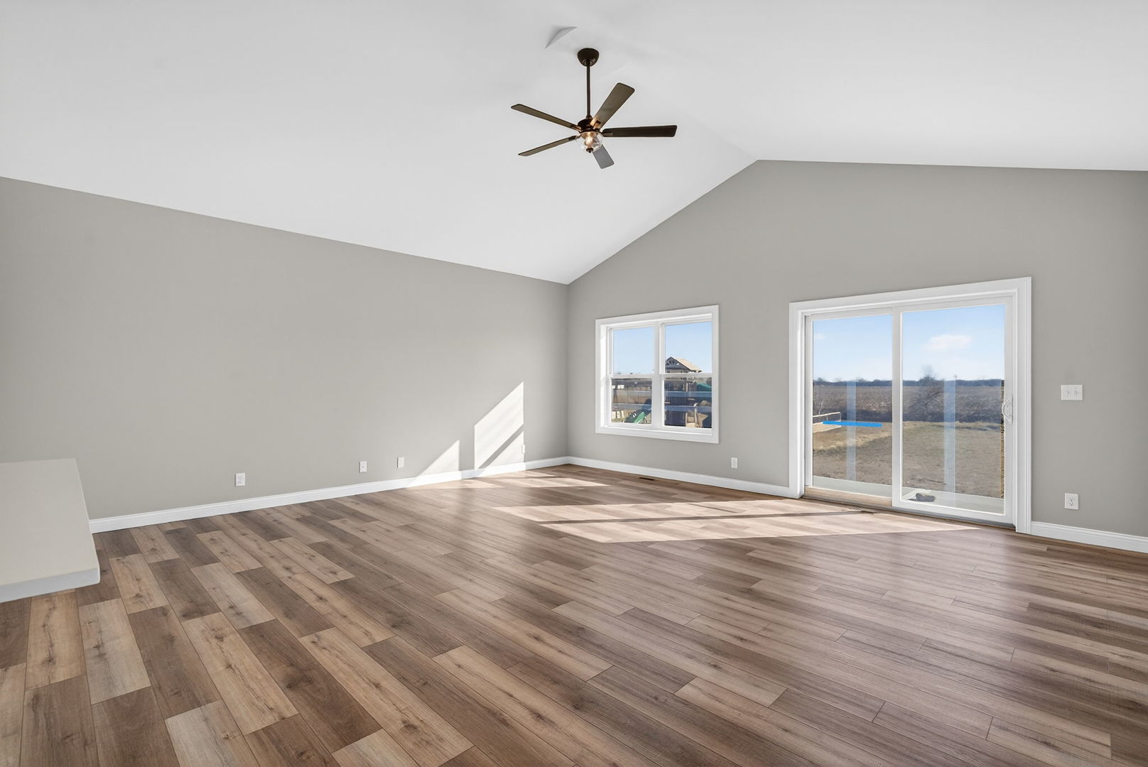 1165 Farmstone Drive Diamond, IL 60416 - Photo 22 of 35 an empty room with wooden floor and windows