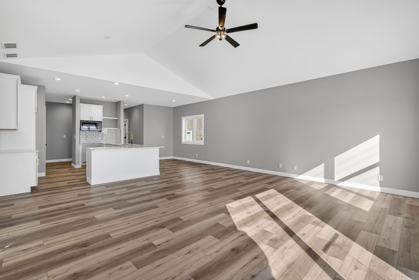 1165 Farmstone Drive Diamond, IL 60416 - Photo 23 of 35 a view of a kitchen with wooden floor and a ceiling fan