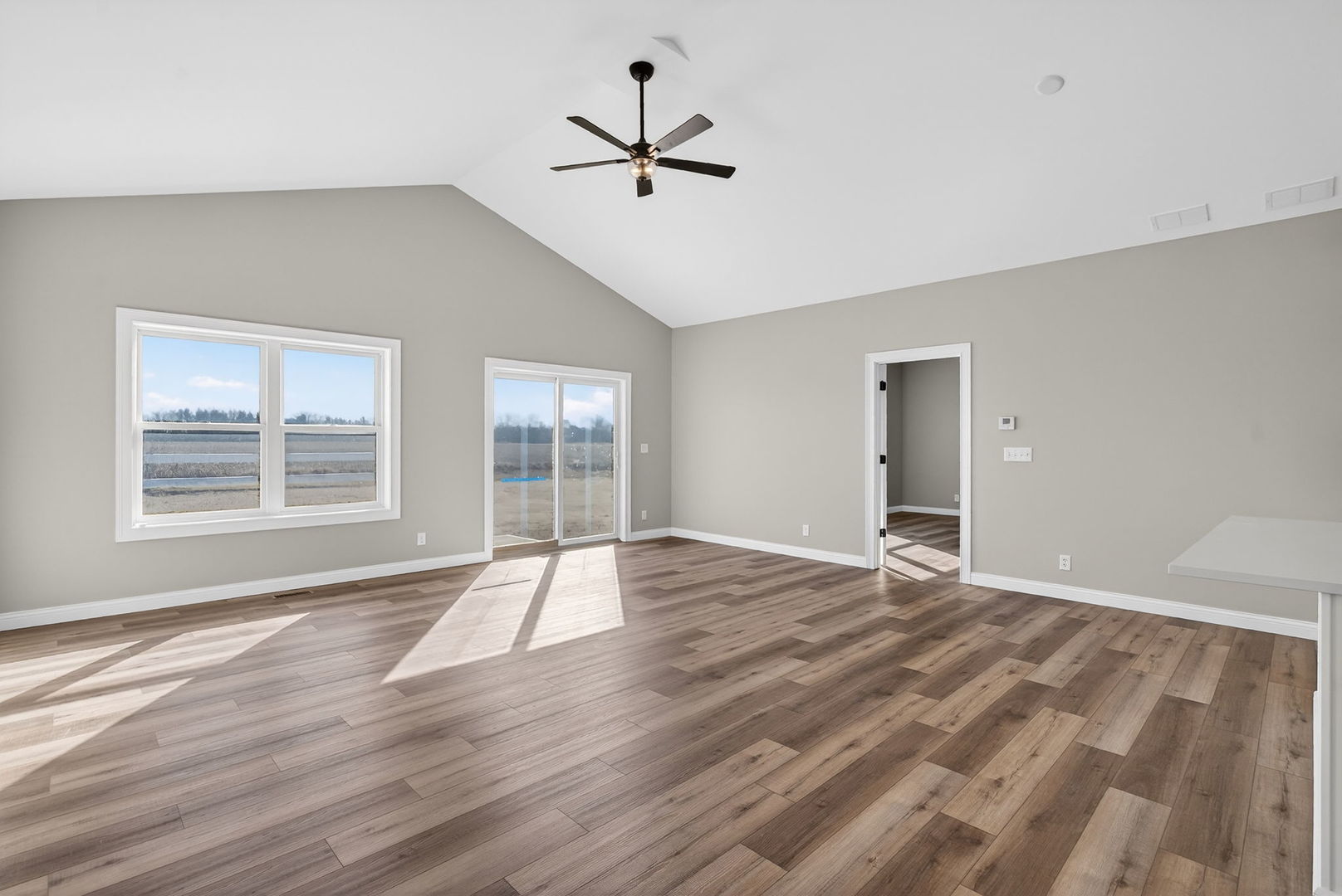 1165 Farmstone Drive Diamond, IL 60416 - Photo 25 of 35 a view of an empty room with wooden floor and a window