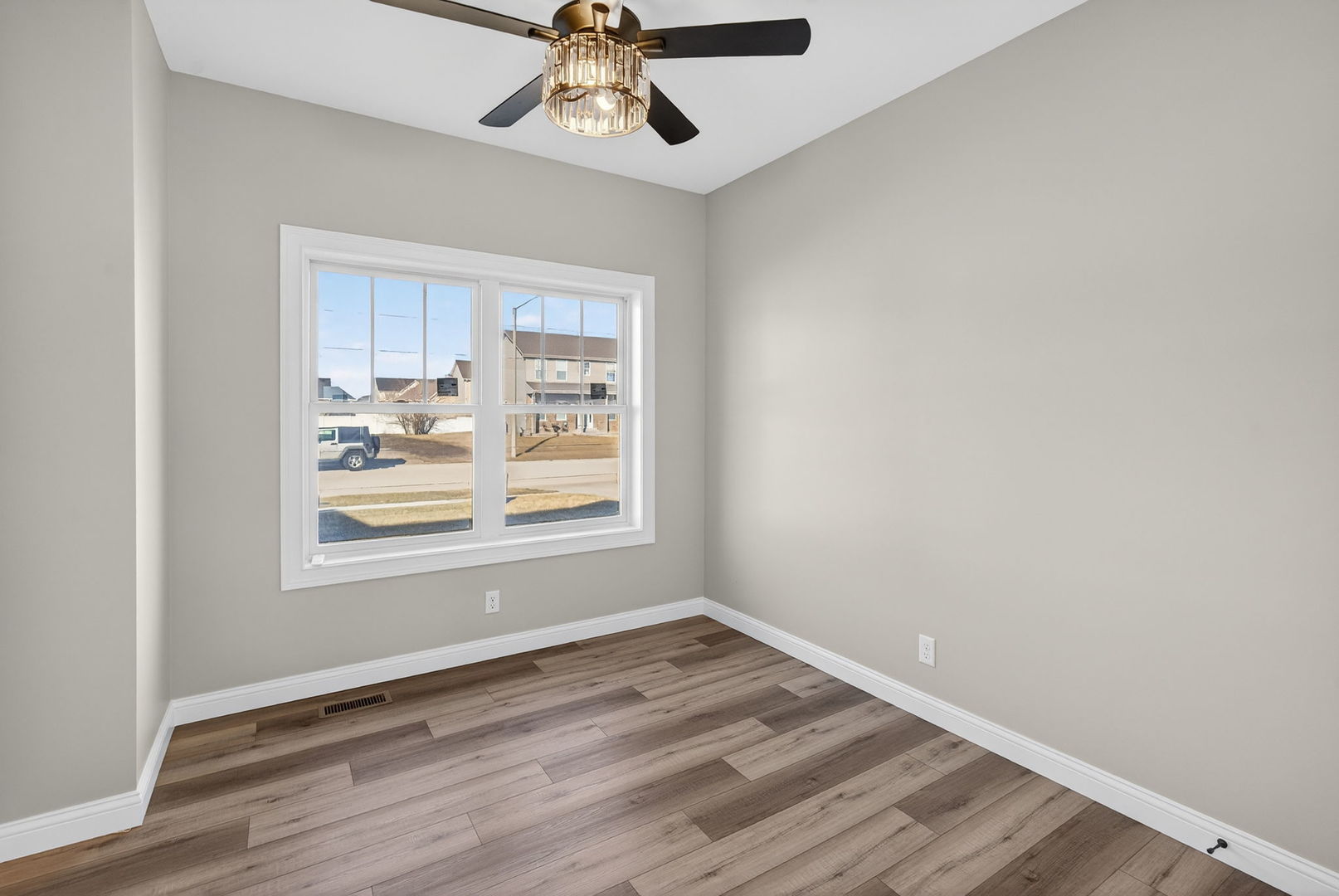 1165 Farmstone Drive Diamond, IL 60416 - Photo 6 of 35 an empty room with wooden floor fan and windows