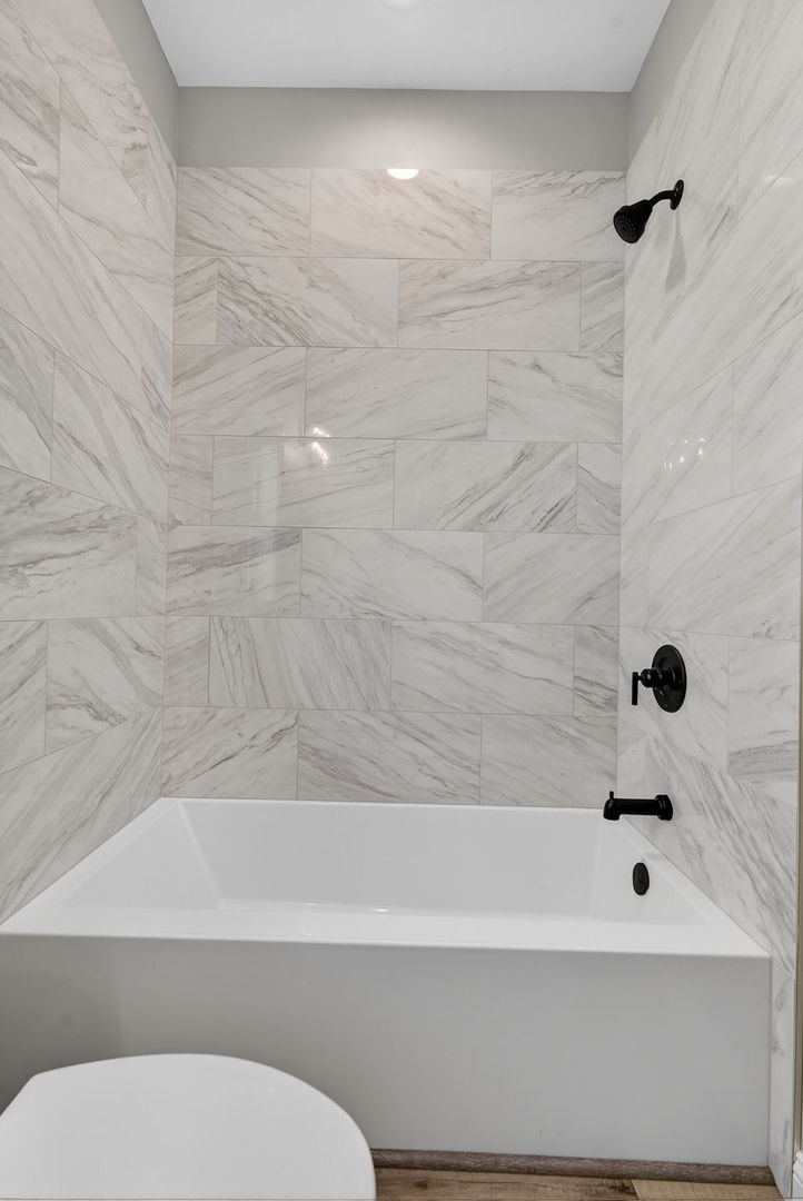 1165 Farmstone Drive Diamond, IL 60416 - Photo 9 of 35 a bathroom with a bathtub and a toilet