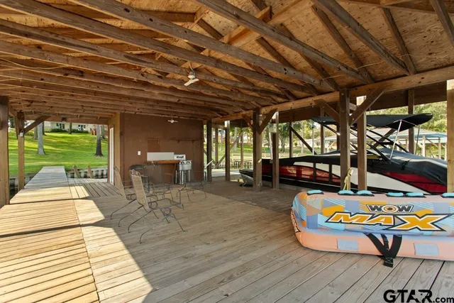 a view of a patio with table and chairs and wooden floor