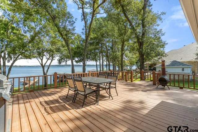 a view of a patio with table and chairs