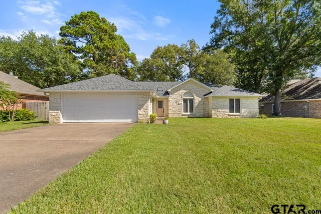 a front view of house with yard and green space