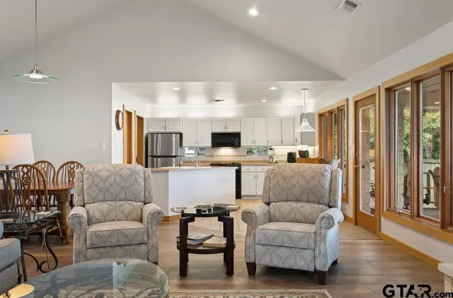 a dining room with furniture a window and wooden floor
