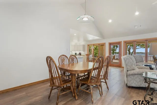 a kitchen with a sink dining table and chairs