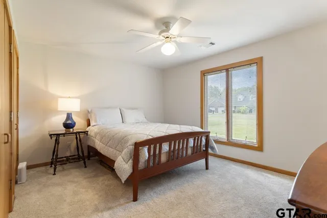 a bedroom with two beds and a flat screen tv