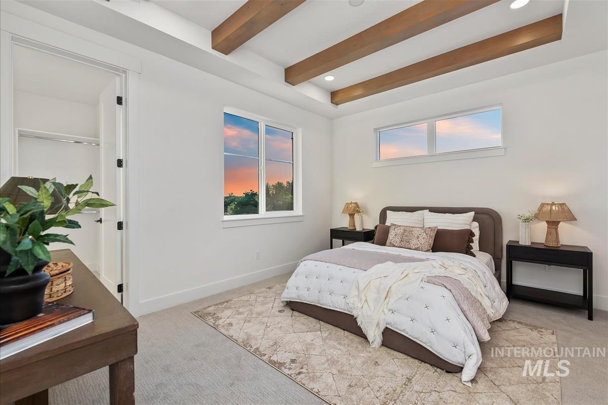 3219 West Moore Street Boise, ID 83702 - Photo 21 of 36 Bright bedroom with exposed wood ceiling beams, recessed lighting, and a large window providing ample natural light