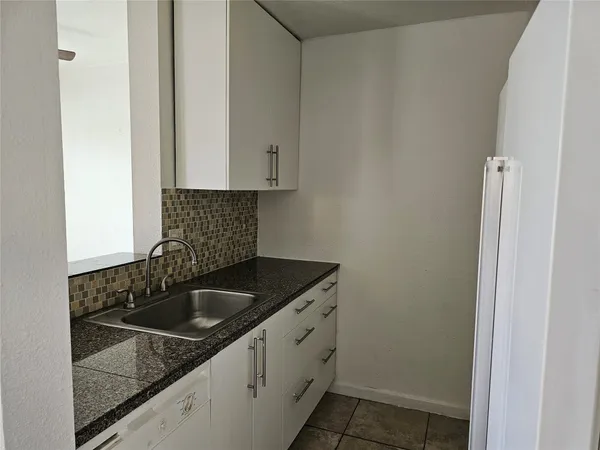 a kitchen with a sink and cabinets