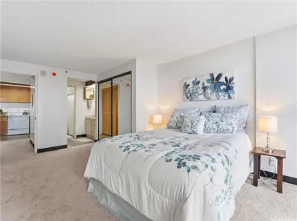 a spacious bedroom with a bed and a painting on the wall