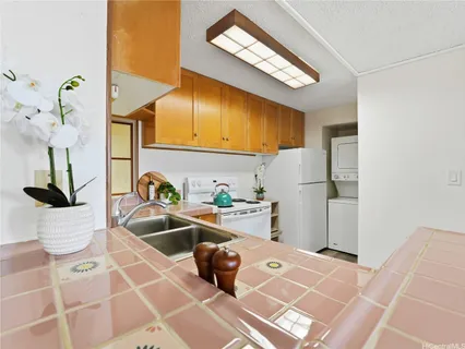 a kitchen with a sink appliances and cabinets