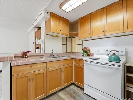 a kitchen with stainless steel appliances granite countertop a sink and cabinets