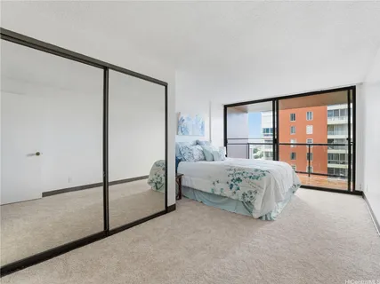 a bedroom with a large bed and a large window