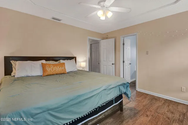 a bedroom with a bed and a chandelier