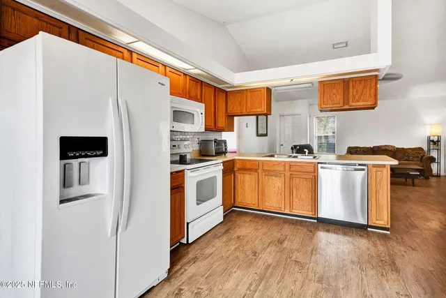 a kitchen with white cabinets and white appliances