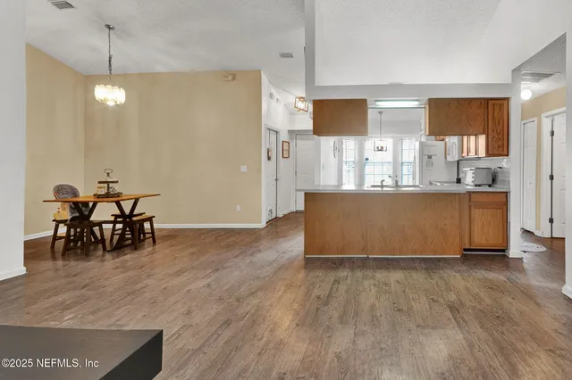 a view of kitchen with furniture and wooden floor