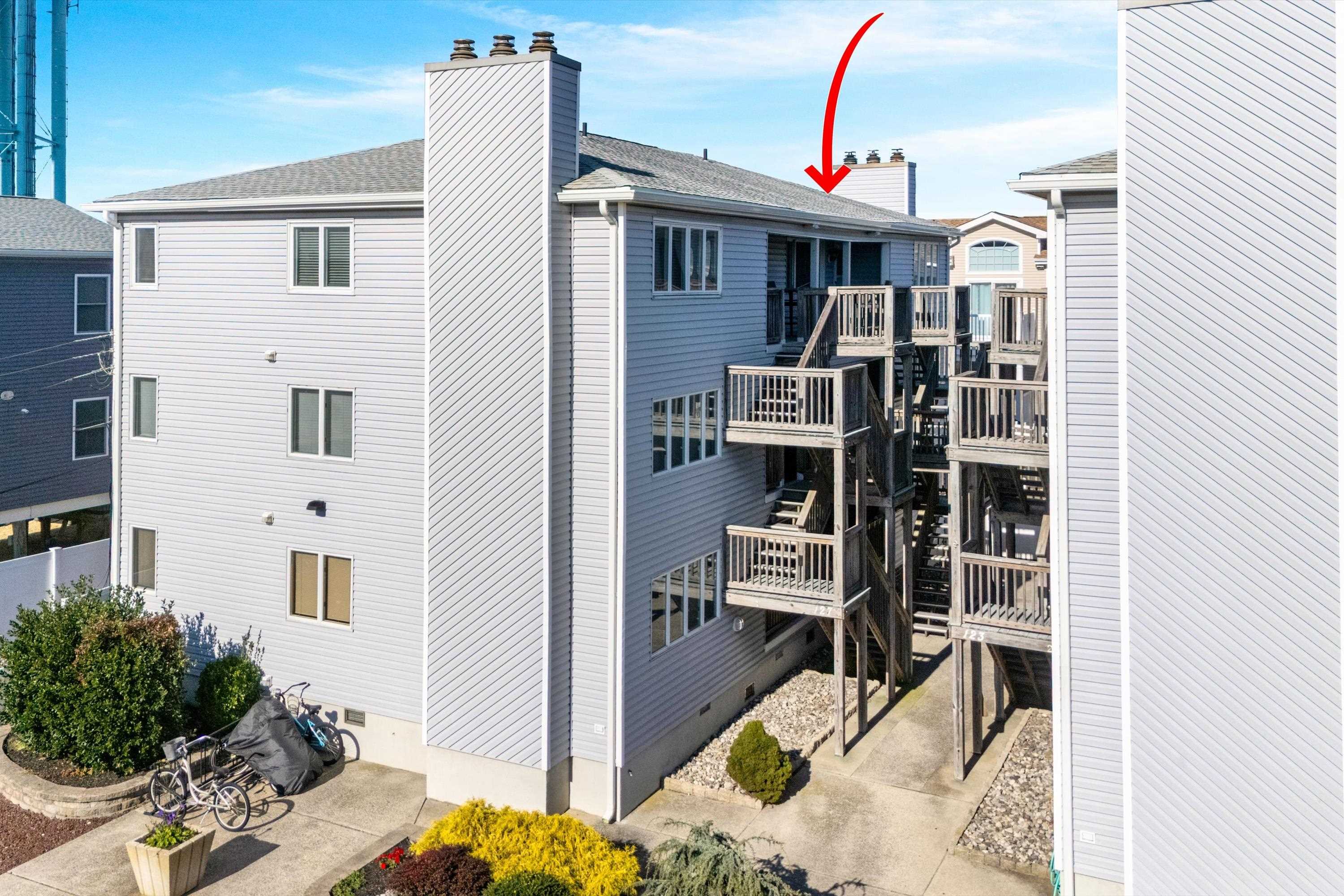 127 40th Street, Unit 1F Sea Isle City, NJ 08243 - Photo 2 of 28 a front view of a house with many windows