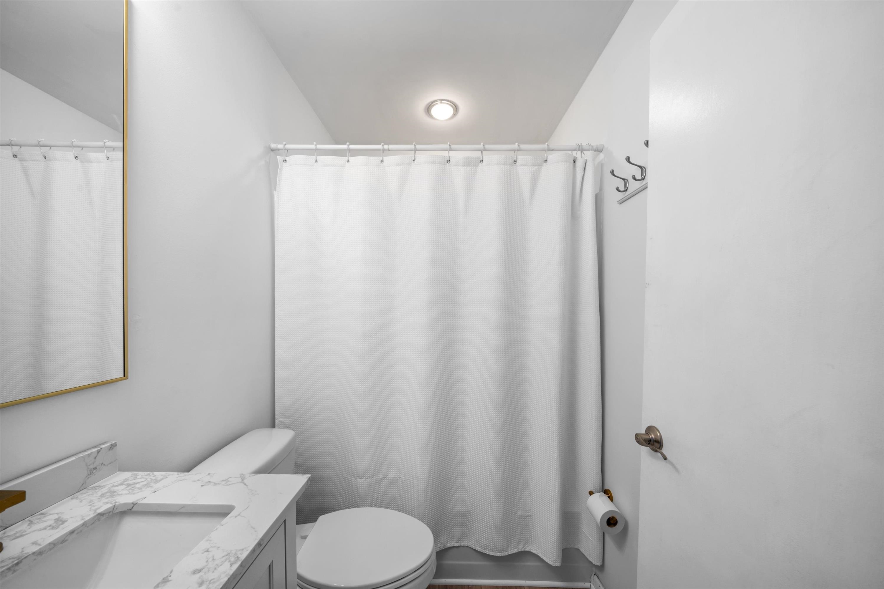 127 40th Street, Unit 1F Sea Isle City, NJ 08243 - Photo 21 of 28 a bathroom with a sink toilet and shower