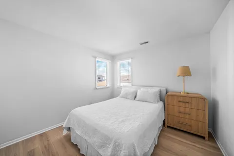 a bedroom with a bed and a night stand