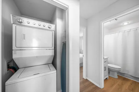 a view of washer and dryer with wooden floor