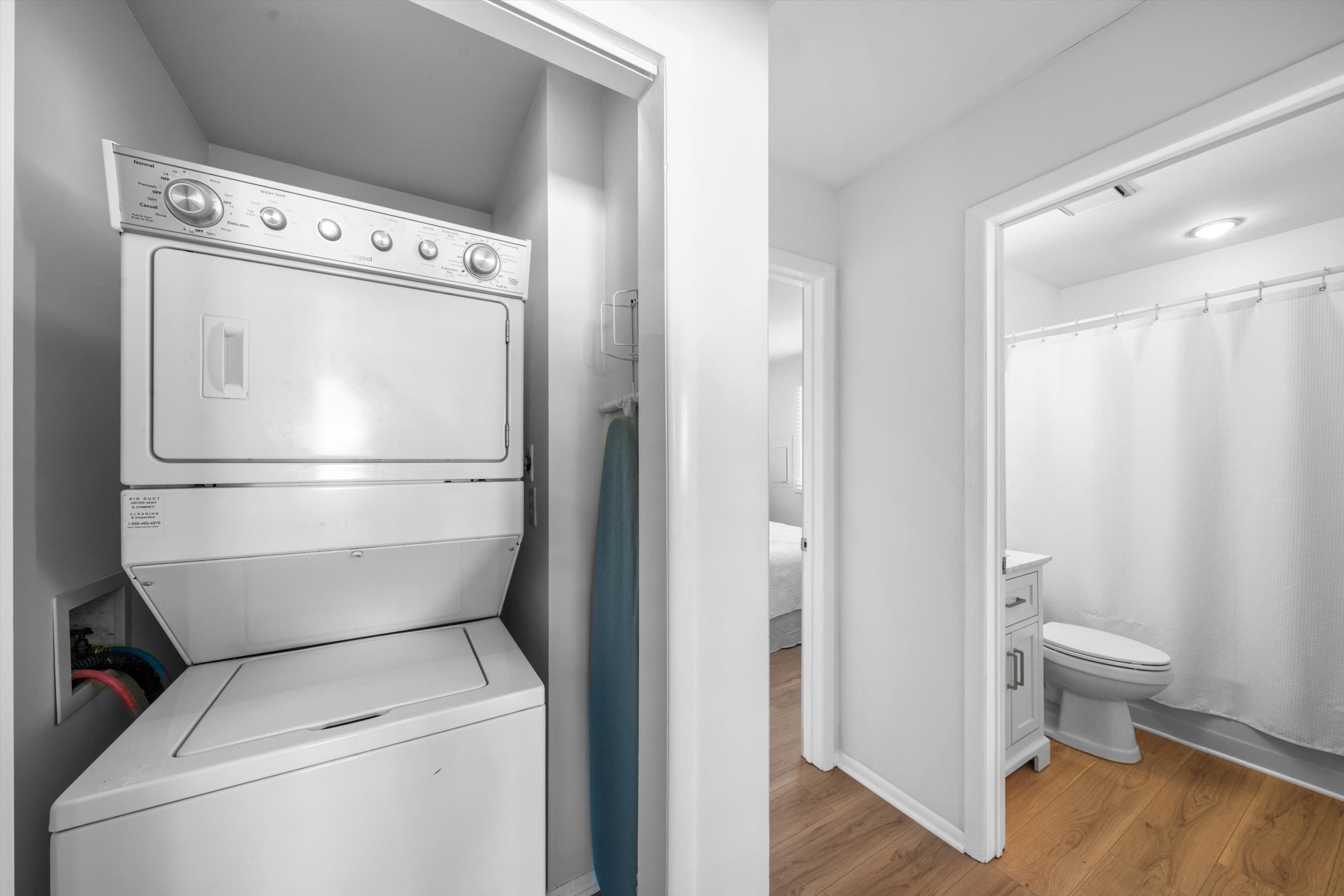 127 40th Street, Unit 1F Sea Isle City, NJ 08243 - Photo 26 of 28 a view of washer and dryer with wooden floor