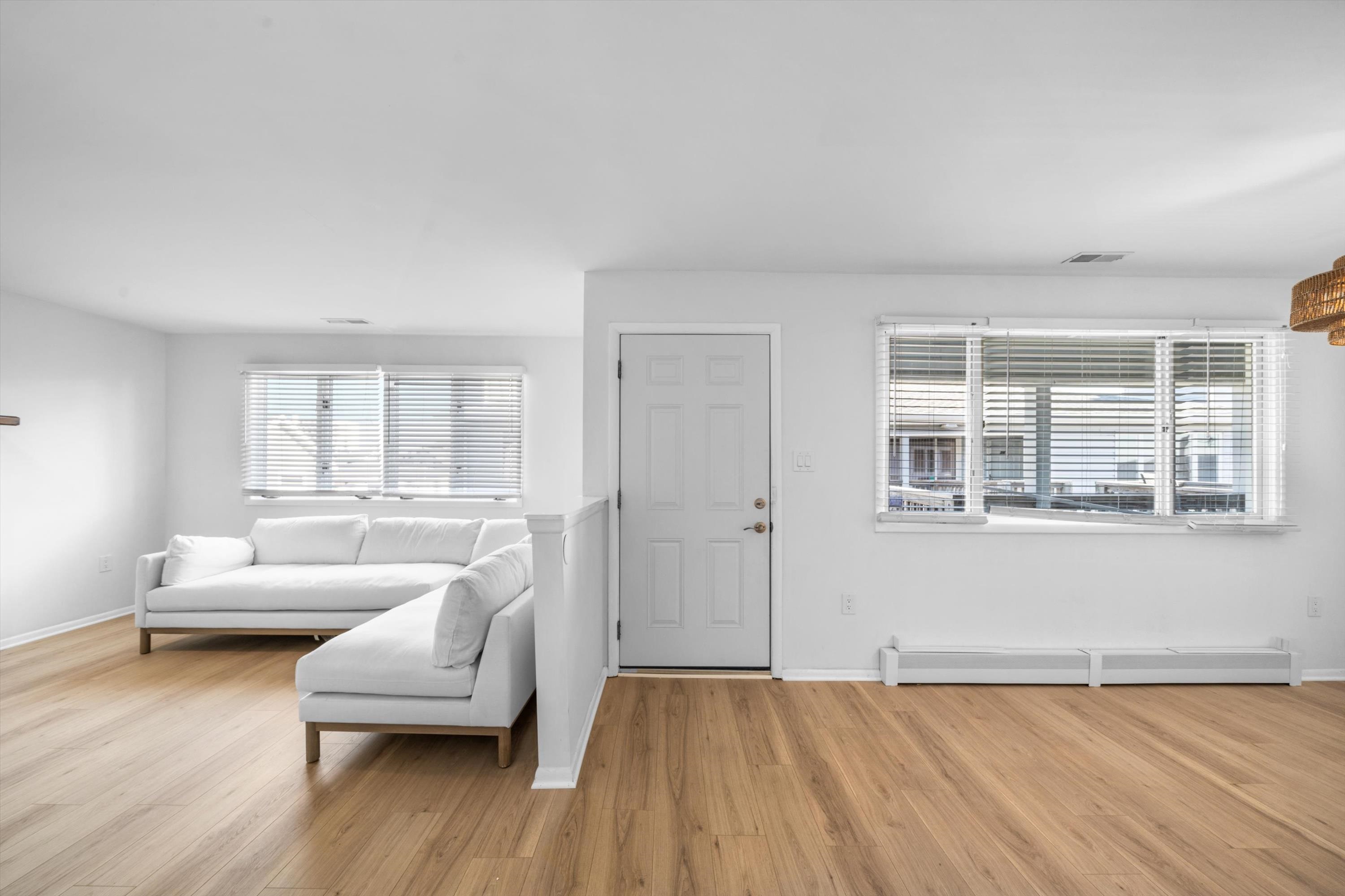 127 40th Street, Unit 1F Sea Isle City, NJ 08243 - Photo 5 of 28 a living room with furniture and a wooden floor