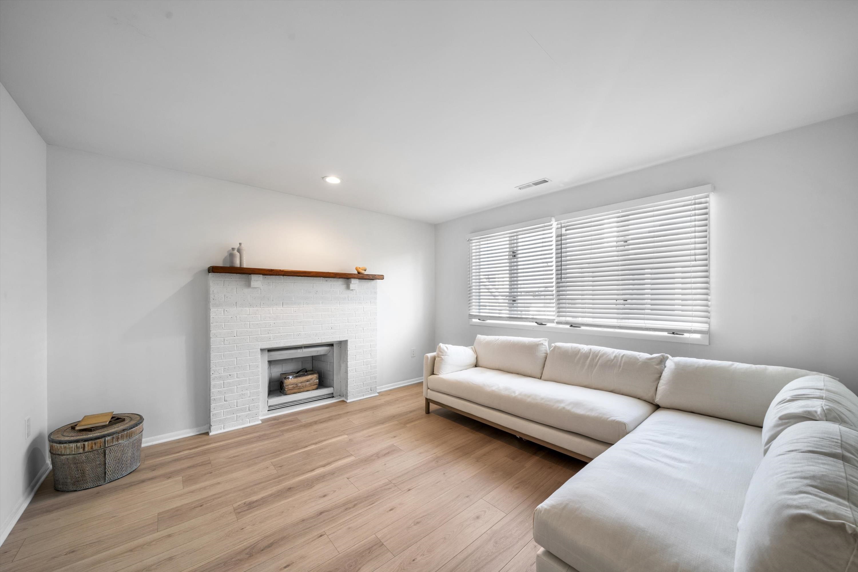 127 40th Street, Unit 1F Sea Isle City, NJ 08243 - Photo 7 of 28 a living room with furniture and a fireplace