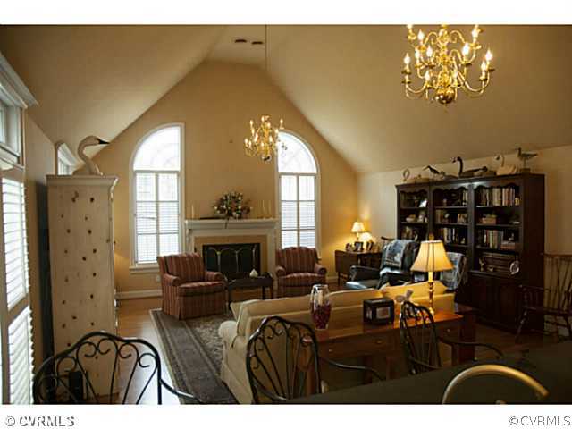 2350 Winterfield Road Midlothian, VA 23113 - Photo 2 of 13 a living room with furniture dining table and a fireplace