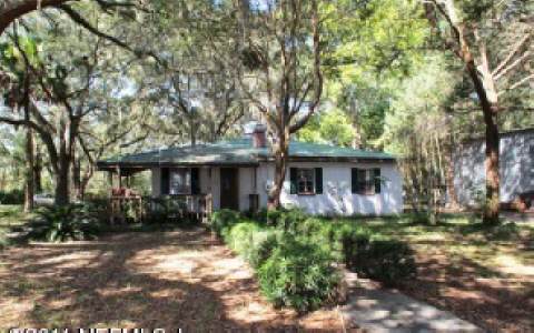96283 Freeman Road Yulee, FL 32097 - Photo 16 of 17 a front view of house with yard and trees