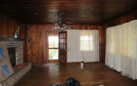 96283 Freeman Road Yulee, FL 32097 - Photo 6 of 17 a view of an empty room with wooden floor and a window